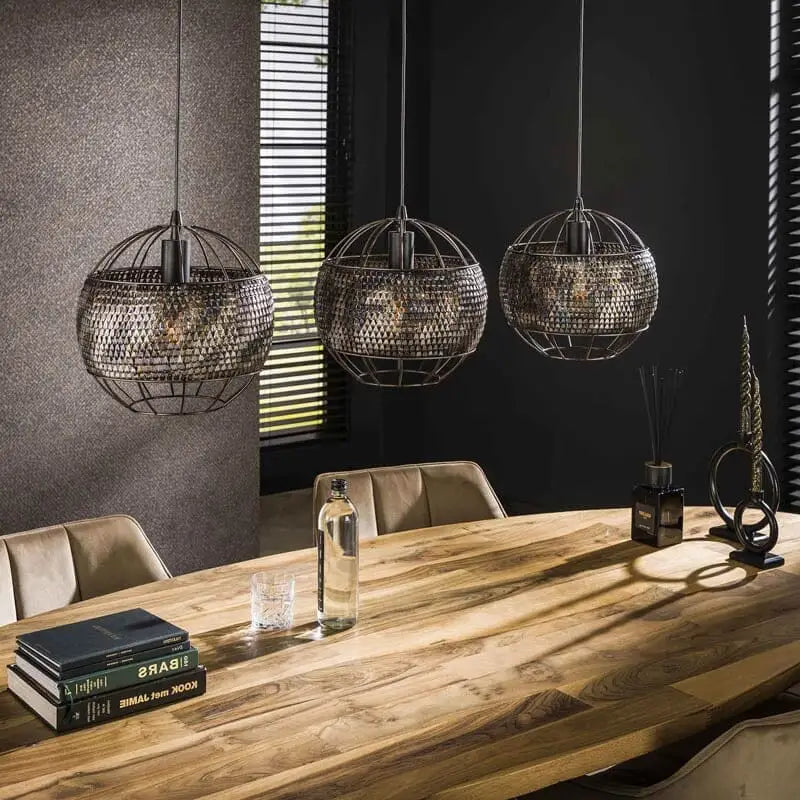 Une atmosphère chaleureuse créée par la lumière douce diffusée à travers les abat-jours de la suspension industrielle "Armor"